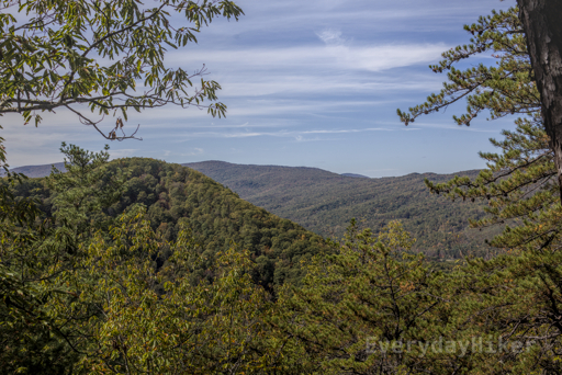 The rolling mountains beginning to yellow under streaky clouds.