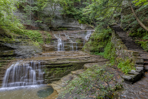 Stairs wrap around this multiple tiered, wide waterfall along Buttermilk Creek.