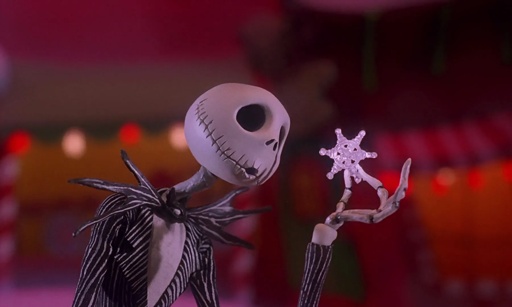 Jack Skellington looking curiously at a snowflake.